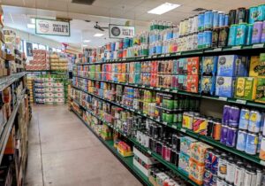 The aisles of a grocery store are full of different types of beer.